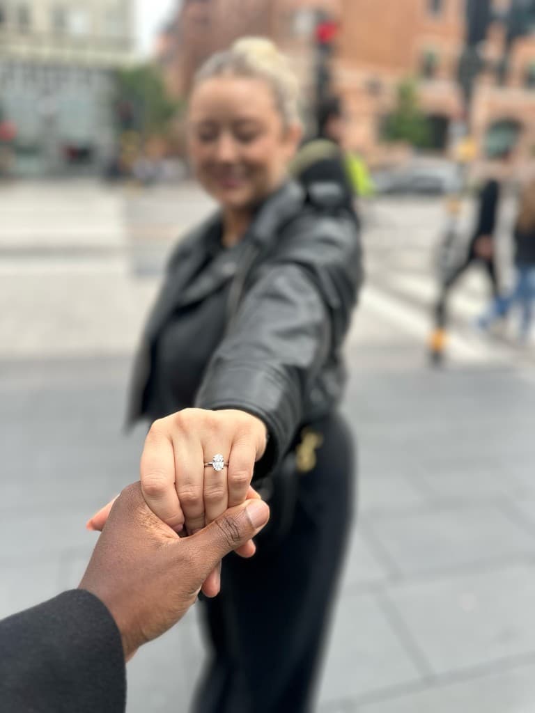 Victor and Amy's hands with engagement ring